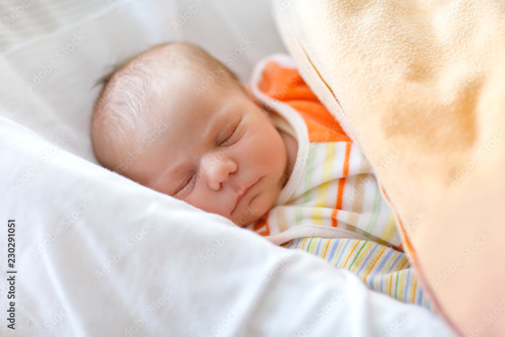 Cute adorable newborn baby sleeping peaceful in bed. New born child, little girl laying in bed. Family, new life, childhood, beginning concept Cute adorable newborn baby sleeping peaceful in bed. New born child, little girl laying in bed. Family, new life, childhood, beginning concept
