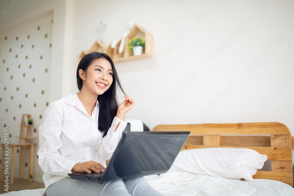 Woman working on laptop computer at home