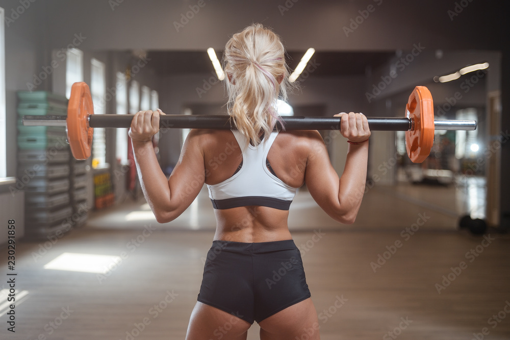 strong sexy athletic young woman working out in gym strong sexy athletic young woman working out in gym
