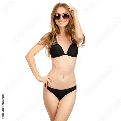 Beautiful woman in swimsuit sunglasses dancing smiling on a white background. Isolation © Kabardins photo