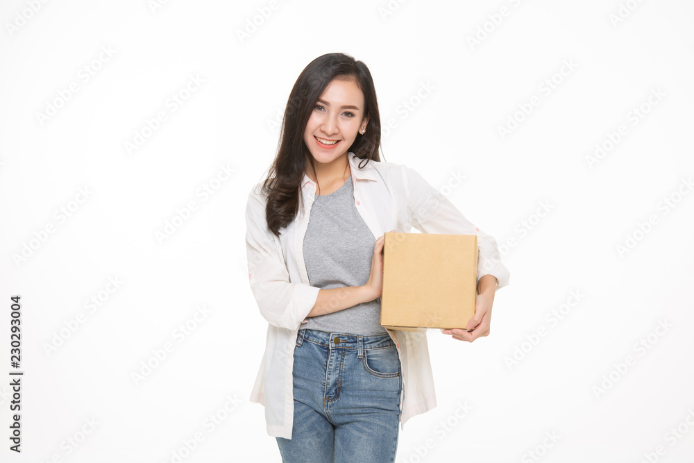 Delivery, relocation and unpacking. Smiling young woman holding cardboard box isolated on white background Delivery, relocation and unpacking. Smiling young woman holding cardboard box isolated on white background
