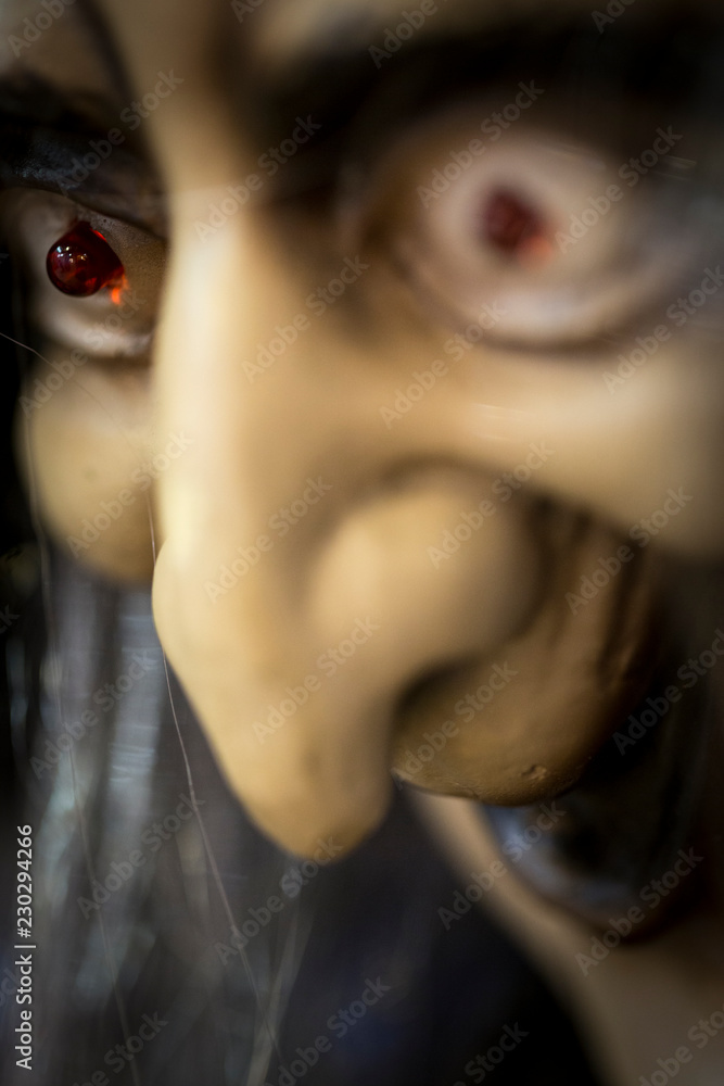 Toy evil witch with illuminating eyes. Modern design of a scary sorcerer  with a big nose. Stock Photo | Adobe Stock