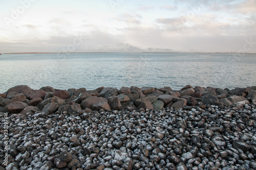 Snow dusted rocks on a beach