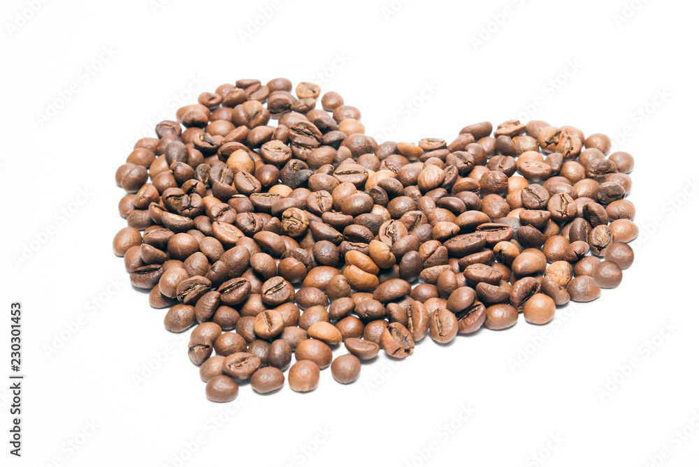 Roasted coffee beans in the shape of a heart on a white background Roasted coffee beans in the shape of a heart on a white background