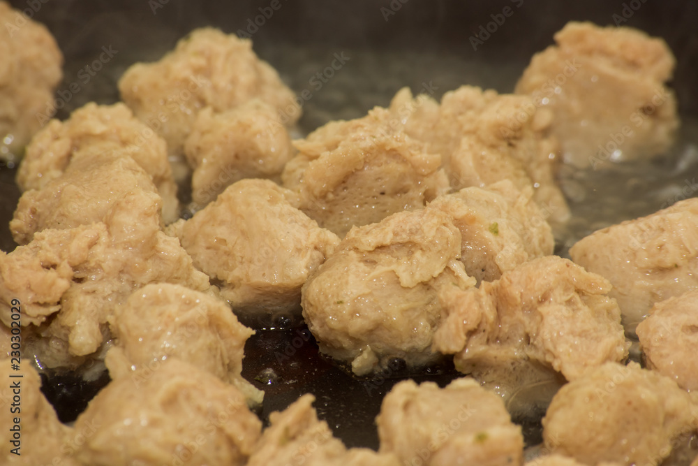 Pieces of soy meat are fried in a pan Pieces of soy meat are fried in a pan