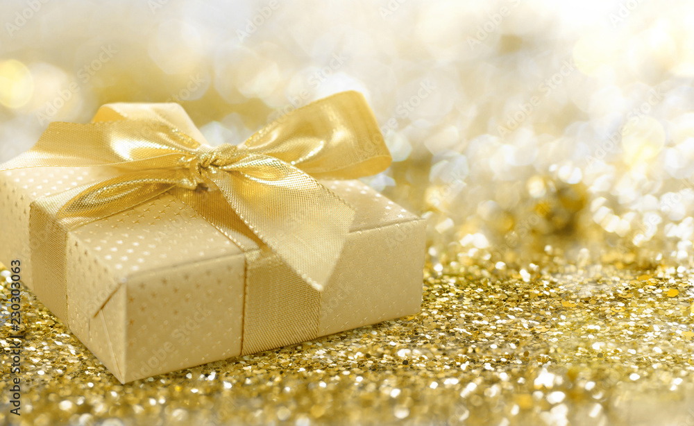 Golden gift box covered with golden foil Golden gift box covered with golden foil