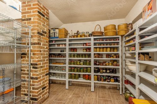 Home food storage room. Various jars with Home Canning Fruits and Vegetables jam on shelves