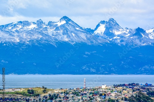 Panoramic view from cruise ship, harbor and snow mountains background Ushuaia City