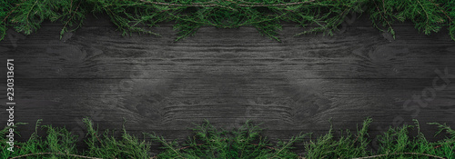 Wallpaper Mural Christmas card. Black wood background with fir branches up and down, top view. Xmas rectangle congratulation. Torontodigital.ca