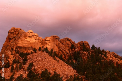 Mount Rushmore in the South Dakota Black Hills National Forest. Summertime with the warm glow of an early evening sun shining on the president's faces