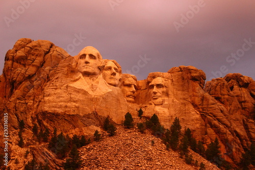 Mount Rushmore in the South Dakota Black Hills National Forest.  Summertime with the warm glow of an early evening sun shining on the president's faces