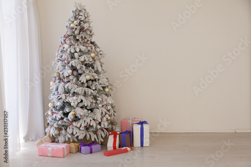 White Christmas tree in Konate with stocking-stuffers photo