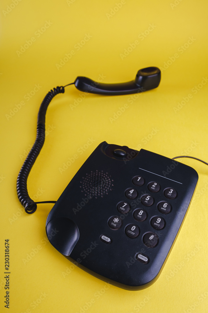 Old fashioned phone on yellow background Old fashioned phone on yellow background