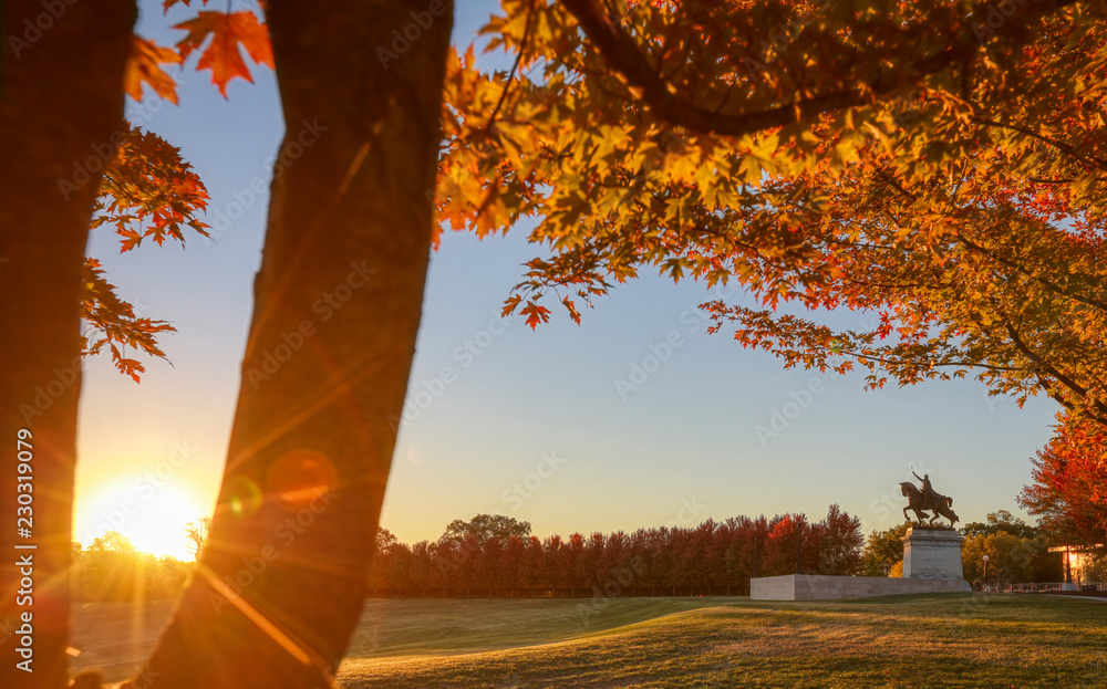 October 20, 2018 - St. Louis, Missouri - The sunrise and fall foliage around the Apotheosis of St. Louis statue of King Louis IX of France on Art Hill in Forest Park, St. Louis, Missouri.