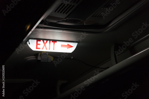Glowing Exit Sign Symbol with Red Arrow