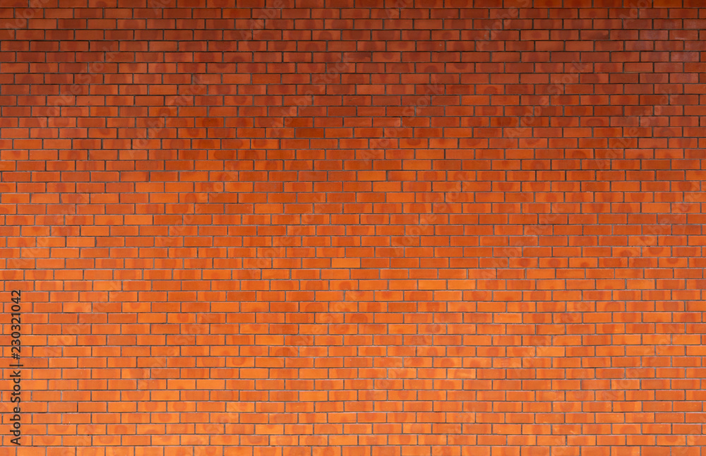 Modern clean orange brick wall with shadow fade from top, vintage building texture and background Modern clean orange brick wall with shadow fade from top, vintage building texture and background