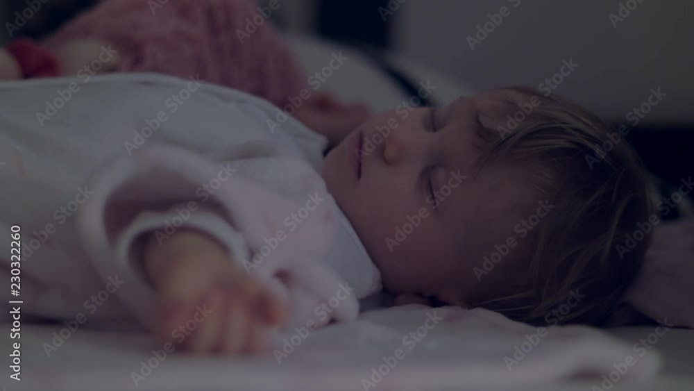 Adorable little girl in a white sleeping with her toys. Close-up. Adorable little girl in a white sleeping with her toys. Close-up.