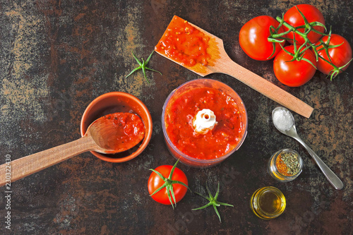 Tomato sauce in a blender cup. Cooking homemade ketchup. Fresh homemade tomato sauce, spices.