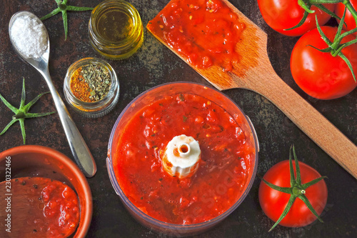 Tomato sauce in a blender cup. Cooking homemade ketchup. Fresh homemade tomato sauce, spices.