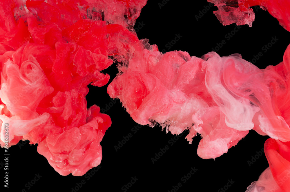 Spill and mix paint in water of red and white colors, on a black background