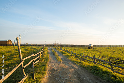 The path to the farm at the Sunset in Velka Lhota along a wooden fence