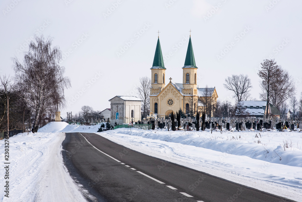Ancient temple, chapel and cemetery, Ukraine. Winter rural landscape