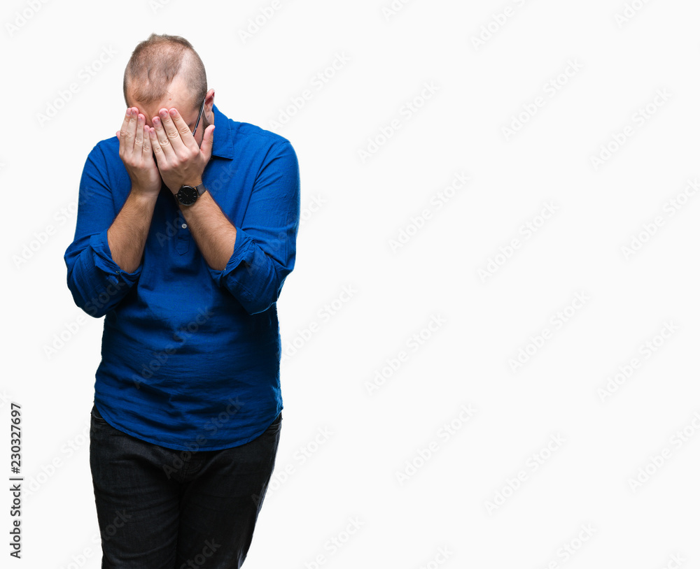 Young caucasian hipster man wearing glasses over isolated background with sad expression covering face with hands while crying. Depression concept. Young caucasian hipster man wearing glasses over isolated background with sad expression covering face with hands while crying. Depression concept.