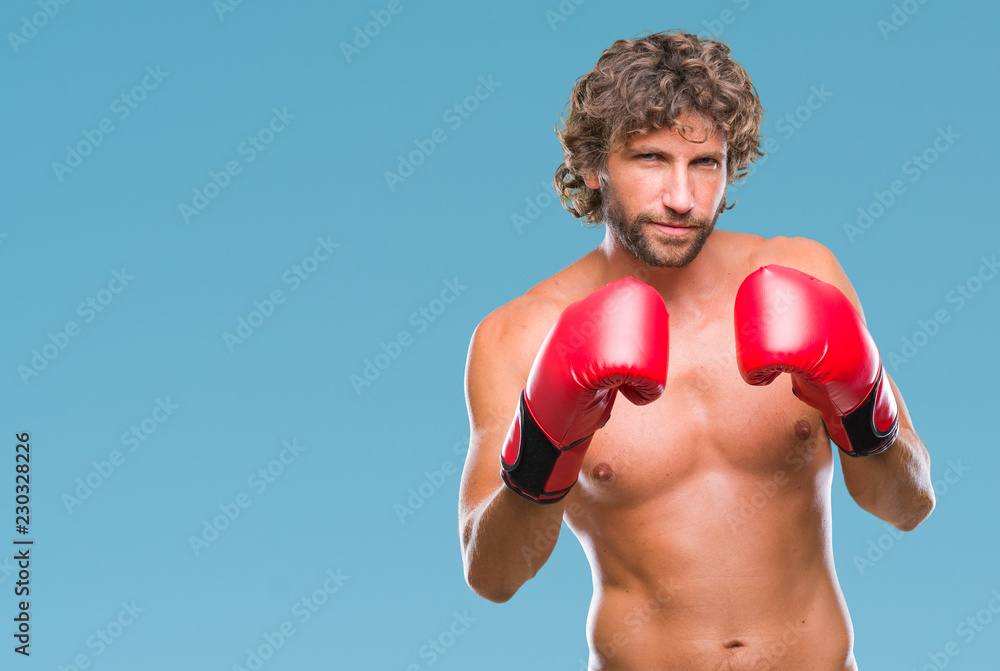 Handsome hispanic boxer man wearing boxing gloves over isolated background skeptic and nervous, frowning upset because of problem. Negative person.