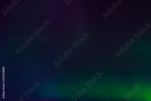 Aurora borealis, northern lights in the night sky with stars