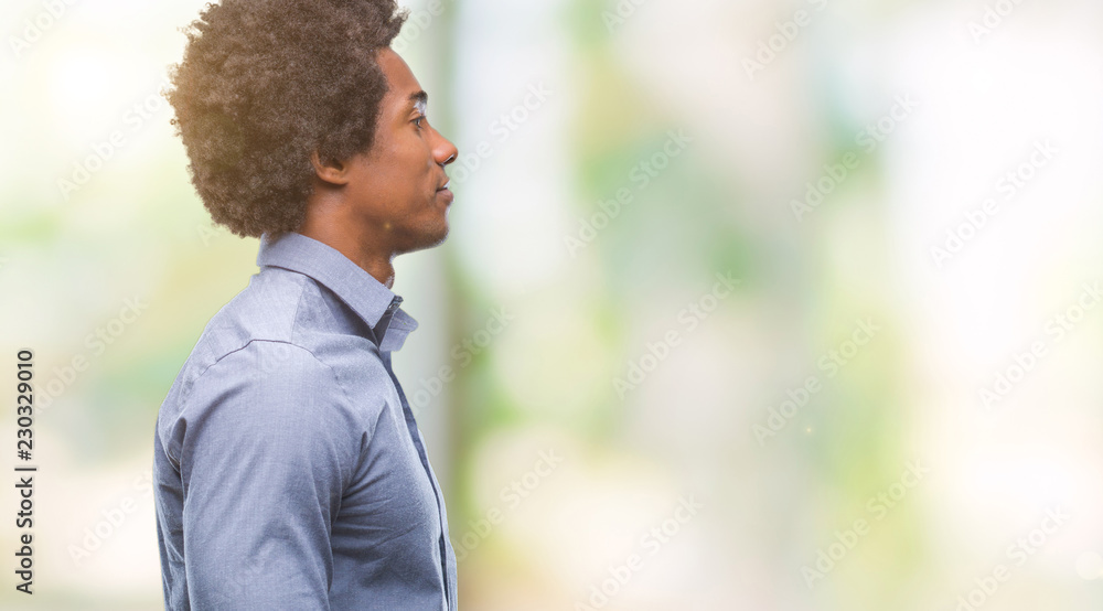 Afro american man over isolated background looking to side, relax profile pose with natural face with confident smile. Afro american man over isolated background looking to side, relax profile pose with natural face with confident smile.