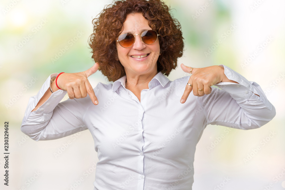 Beautiful middle ager senior business woman wearing sunglasses over isolated background looking confident with smile on face, pointing oneself with fingers proud and happy. Beautiful middle ager senior business woman wearing sunglasses over isolated background looking confident with smile on face, pointing oneself with fingers proud and happy.
