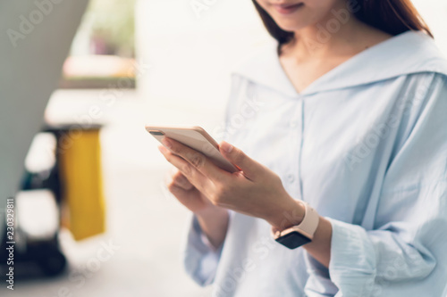 Woman using smartphone, During leisure time. The concept of using the phone is essential in everyday life. © sitthiphong