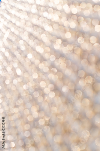 Abstract gold bokeh background, metal surface is not in focus