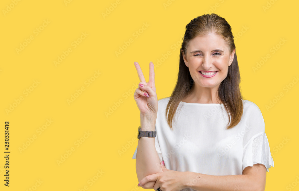 Middle age mature beautiful woman over isolated background smiling with happy face winking at the camera doing victory sign. Number two. Middle age mature beautiful woman over isolated background smiling with happy face winking at the camera doing victory sign. Number two.