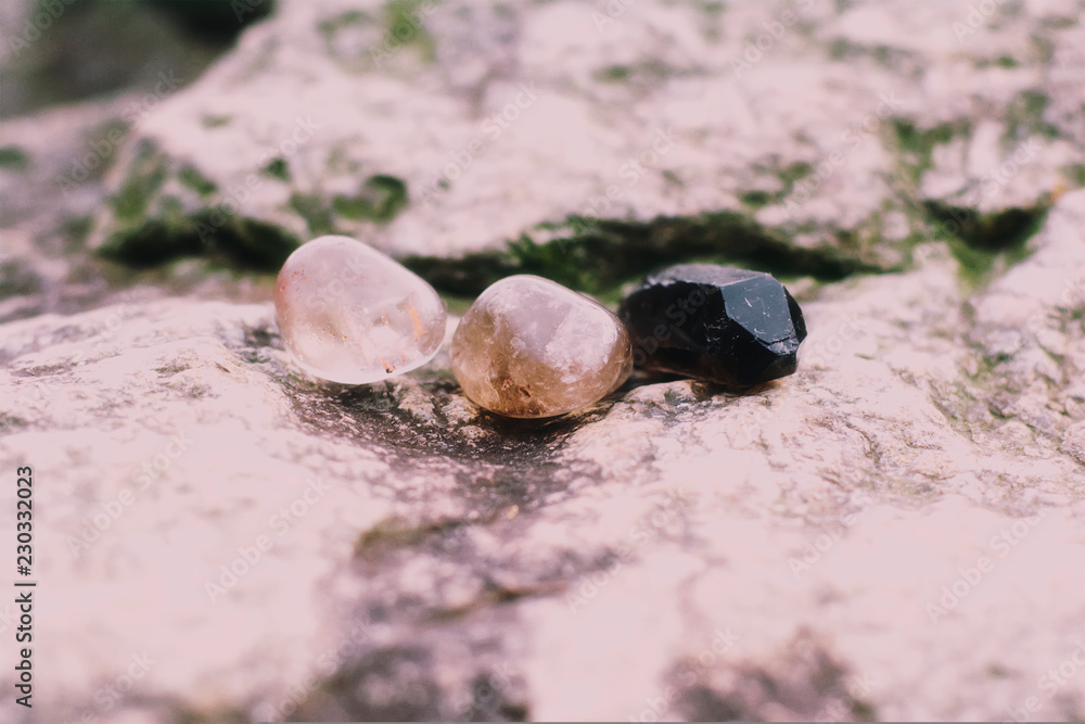 Three shades of smokey quartz on a rock Three shades of smokey quartz on a rock