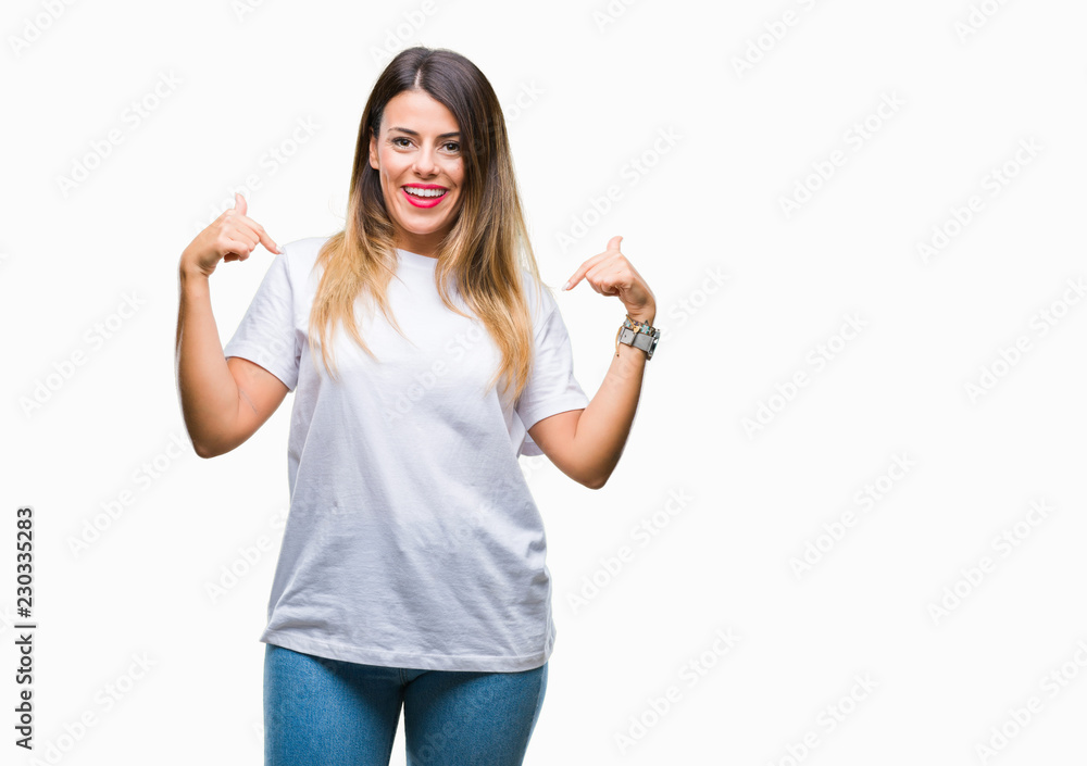 Young beautiful woman casual white t-shirt over isolated background looking confident with smile on face, pointing oneself with fingers proud and happy. - obrazy, fototapety, plakaty 