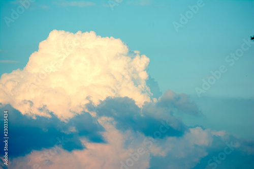 Blue sky with big clouds. Summer time of the year. Warm July evening. Nature photo for design. Outdoor stay