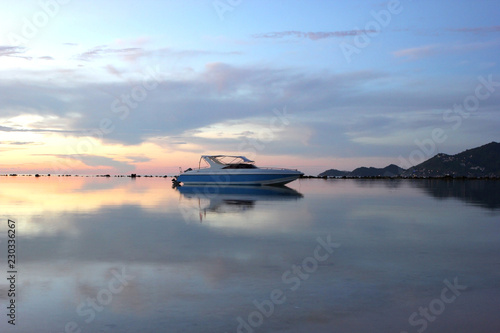 speed boat in the sea with beautiful sunrise