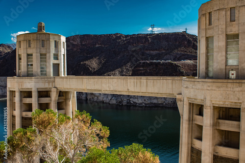 Hoover dam buildings with a green tree on foreground