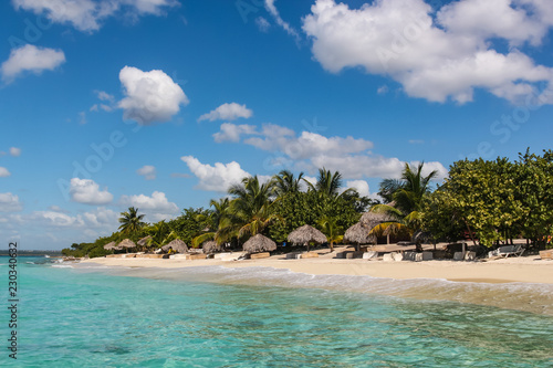 Fototapeta Naklejka Na Ścianę i Meble -  beach with reed umbrellas on island in the Dominican Republic