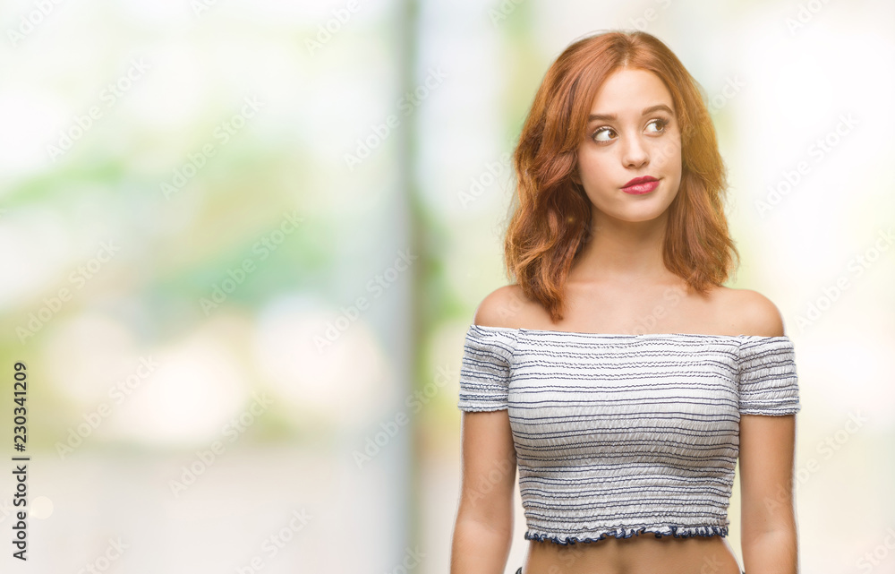 Young beautiful woman over isolated background smiling looking side and staring away thinking. Young beautiful woman over isolated background smiling looking side and staring away thinking.