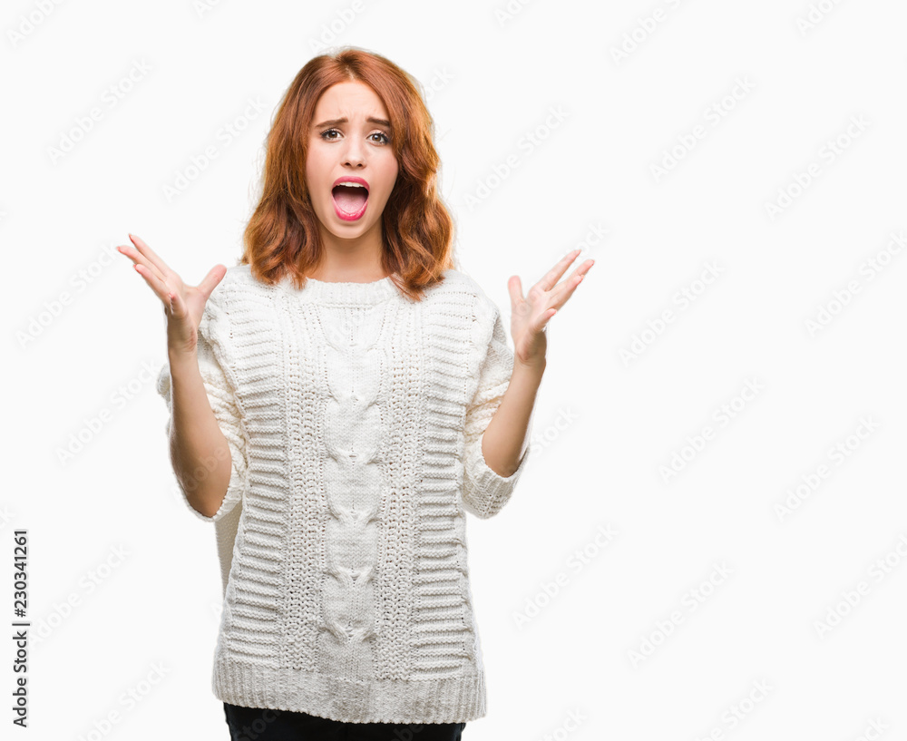 Young beautiful woman over isolated background wearing winter sweater celebrating crazy and amazed for success with arms raised and open eyes screaming excited. Winner concept Young beautiful woman over isolated background wearing winter sweater celebrating crazy and amazed for success with arms raised and open eyes screaming excited. Winner concept
