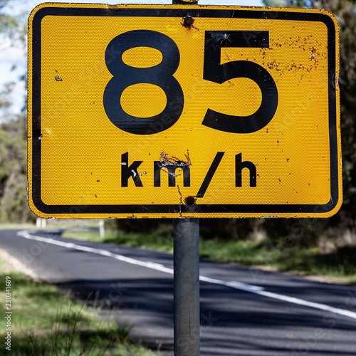 Battered 85 kmh warning sign. Inspiration for adventure, travel memories and brochures of signs for tourists. Could be found in any country - no words. Metaphor for #metoo and slowing down. photo