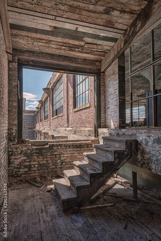 HDR image of the abandoned (now demolished) Scranton Lace Factory in Scranton, Pennsylvania.  Image shows the brick exterior and interior wooden stairs.