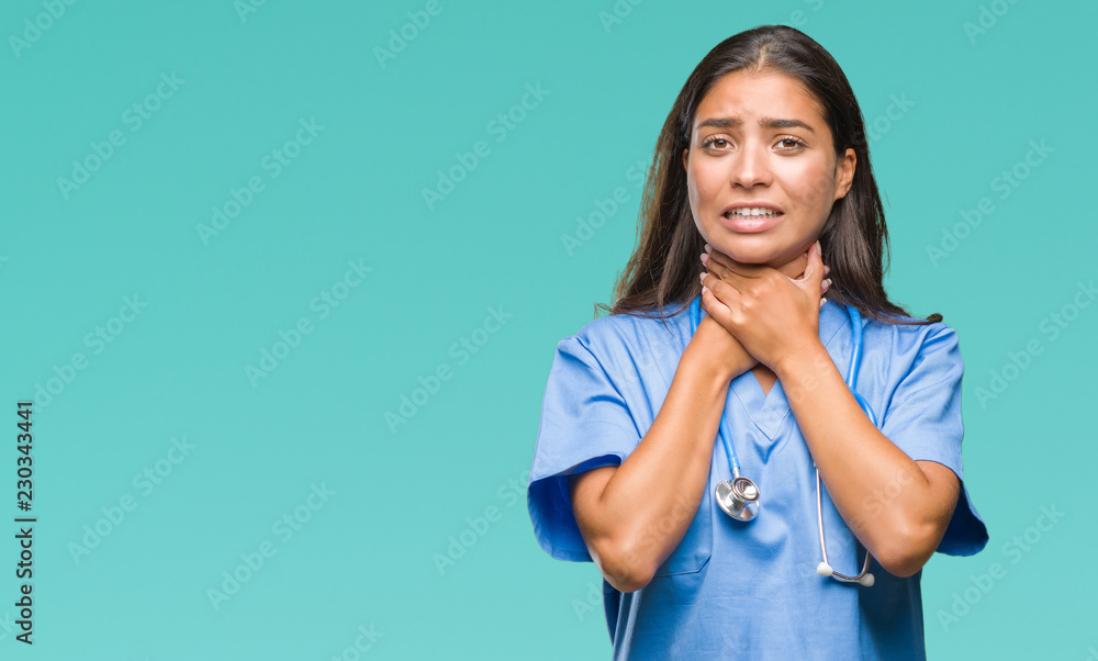 Young arab doctor surgeon woman over isolated background shouting and suffocate because painful strangle. Health problem. Asphyxiate and suicide concept. Young arab doctor surgeon woman over isolated background shouting and suffocate because painful strangle. Health problem. Asphyxiate and suicide concept.