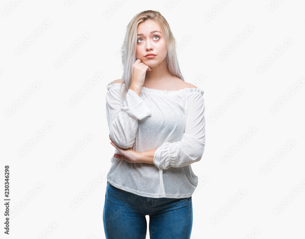 Young blonde woman over isolated background with hand on chin thinking about question, pensive expression. Smiling with thoughtful face. Doubt concept. Young blonde woman over isolated background with hand on chin thinking about question, pensive expression. Smiling with thoughtful face. Doubt concept.