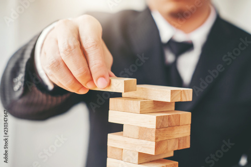 Businessman plan and strategy in business Domino Effect Problem Solving