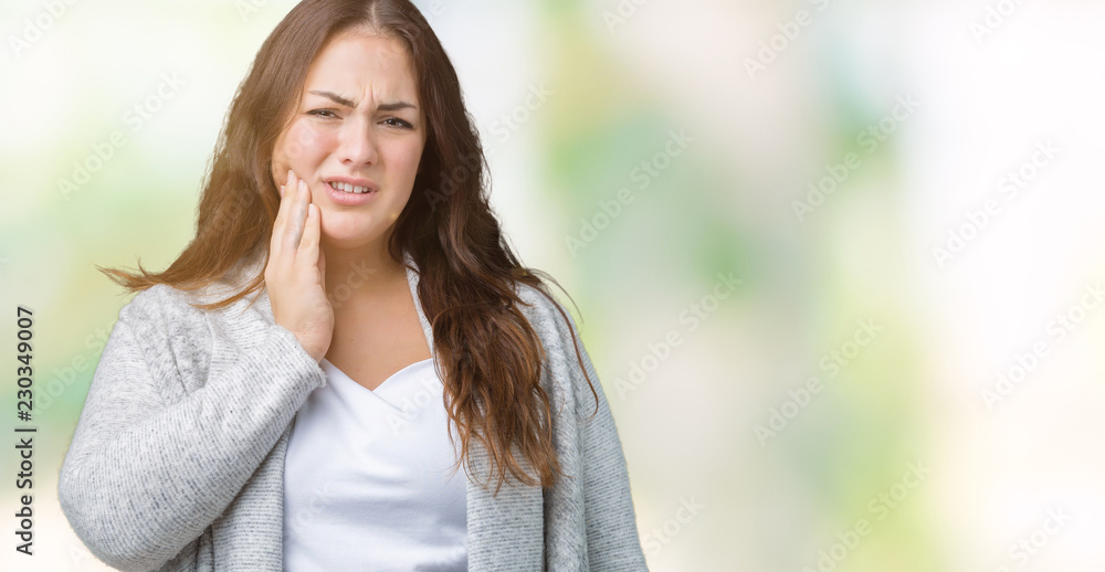 Beautiful plus size young woman wearing winter jacket over isolated background touching mouth with hand with painful expression because of toothache or dental illness on teeth. Dentist concept.
