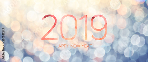 Happy new year 2019 banner with pale yellow and blue bokeh light sparkling background,Holiday greeting card.