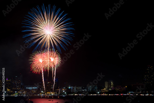Fireworks explored over cityscape at night in sea port in Pattaya.Holiday festive celebration background. © weedezign